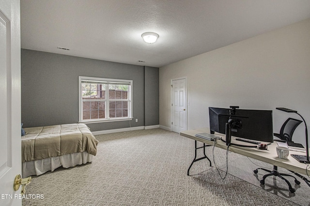 bedroom featuring carpet floors and a textured ceiling