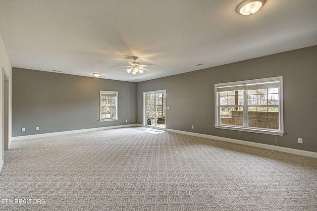 carpeted spare room featuring ceiling fan
