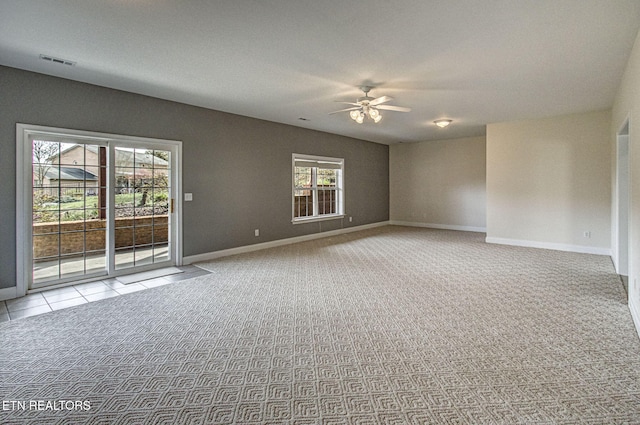 spare room with light colored carpet and ceiling fan