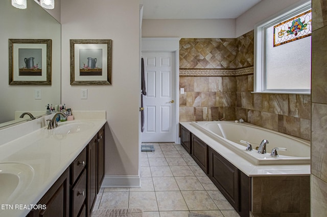 bathroom with tile patterned flooring, vanity, and a tub