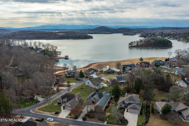 drone / aerial view featuring a water and mountain view