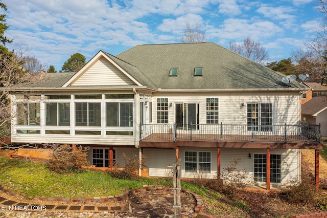 back of property with a sunroom