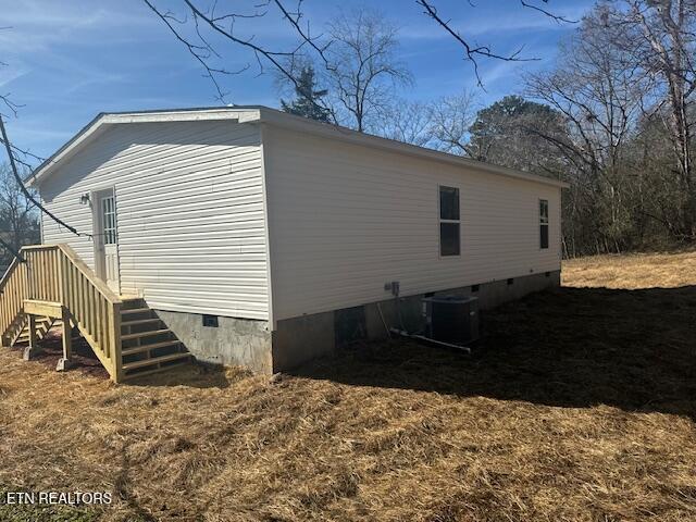 view of side of property featuring central AC