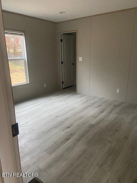 empty room with hardwood / wood-style floors