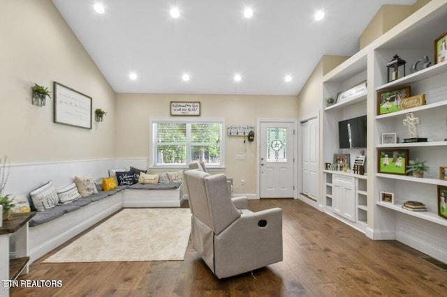 living room with high vaulted ceiling and dark hardwood / wood-style floors