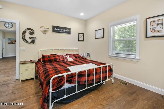 bedroom featuring dark hardwood / wood-style flooring