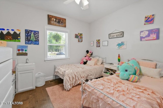 bedroom with ceiling fan and dark hardwood / wood-style flooring