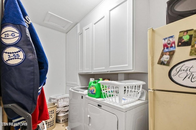 laundry area with cabinets and washing machine and clothes dryer