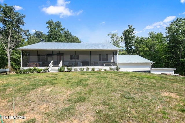 view of front facade featuring a sunroom and a front yard