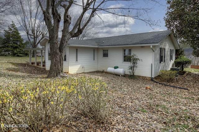 rear view of property with a shingled roof