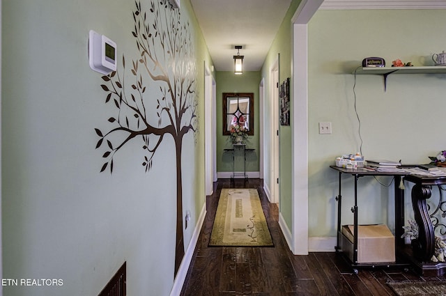 corridor with baseboards and wood-type flooring