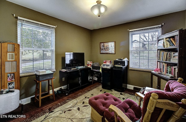 office area featuring baseboards and wood finished floors