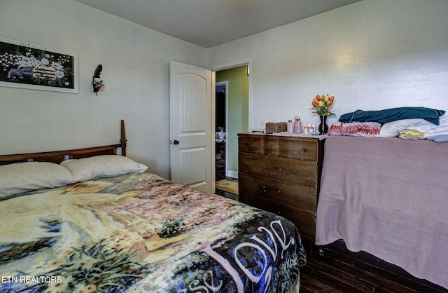 bedroom featuring dark wood-style flooring