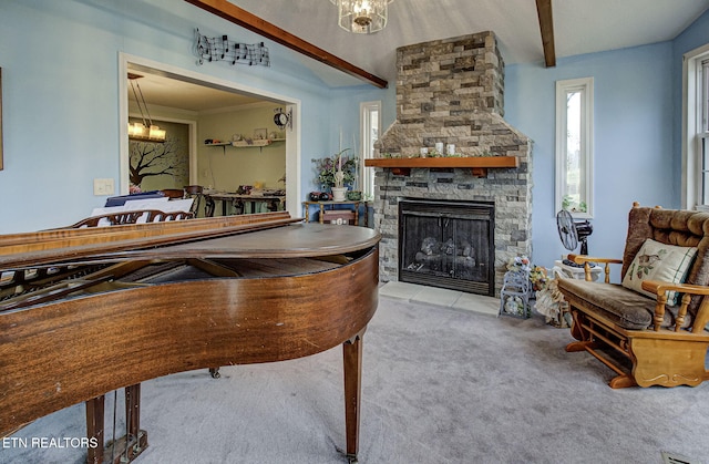 game room with a stone fireplace, beam ceiling, a notable chandelier, and carpet floors