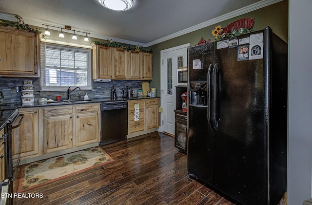 kitchen featuring dark countertops, light brown cabinets, crown molding, black appliances, and a sink