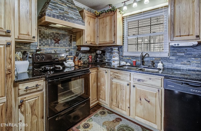 kitchen featuring premium range hood, backsplash, black appliances, and a sink