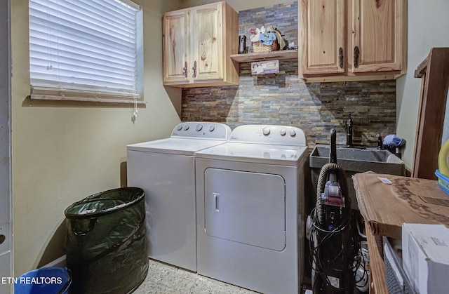 laundry room featuring a sink, cabinet space, and washer and clothes dryer