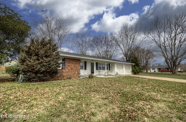 ranch-style home featuring brick siding, a garage, concrete driveway, and a front yard