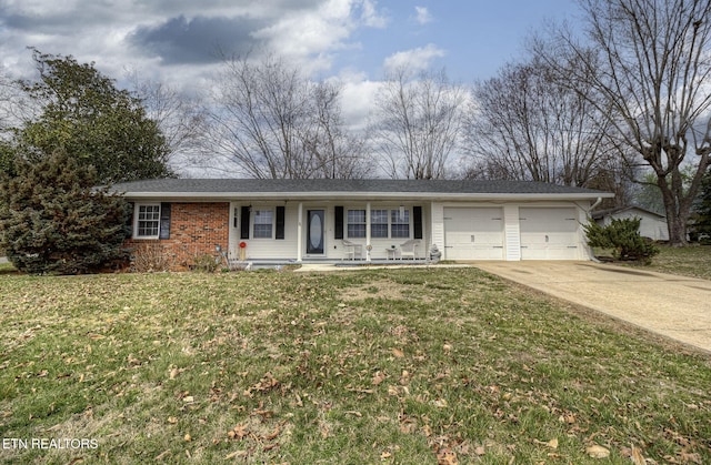 single story home featuring a front yard, driveway, a porch, a garage, and brick siding