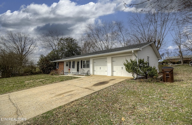 ranch-style home with a front yard, concrete driveway, and an attached garage