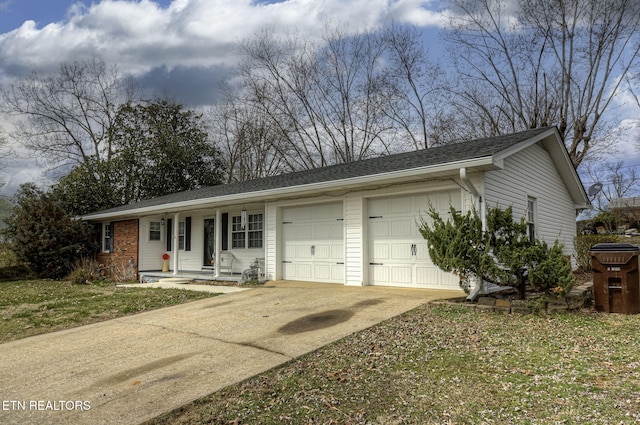 single story home with a porch, an attached garage, and driveway