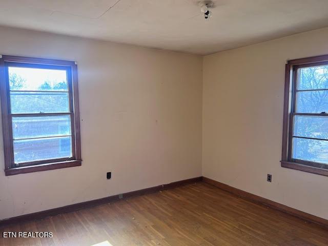 unfurnished room with dark hardwood / wood-style floors