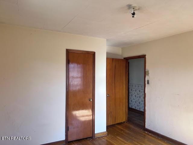 unfurnished bedroom featuring dark wood-type flooring