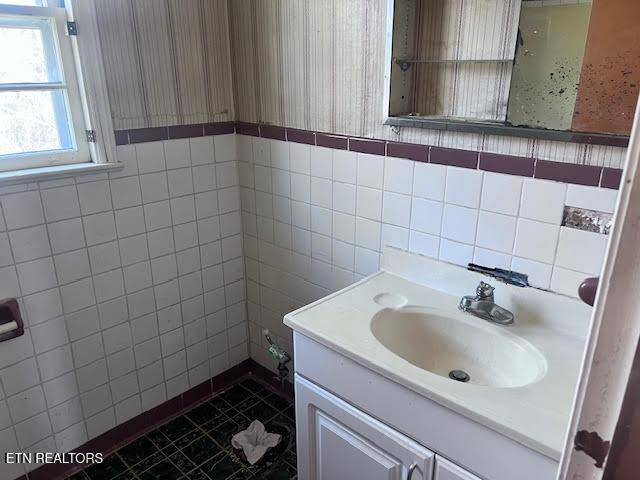 bathroom featuring tile walls, vanity, and tile patterned flooring