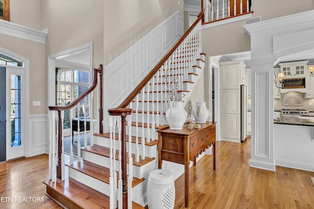 foyer with a towering ceiling and light hardwood / wood-style flooring