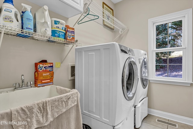 washroom with tile patterned floors and washer and dryer