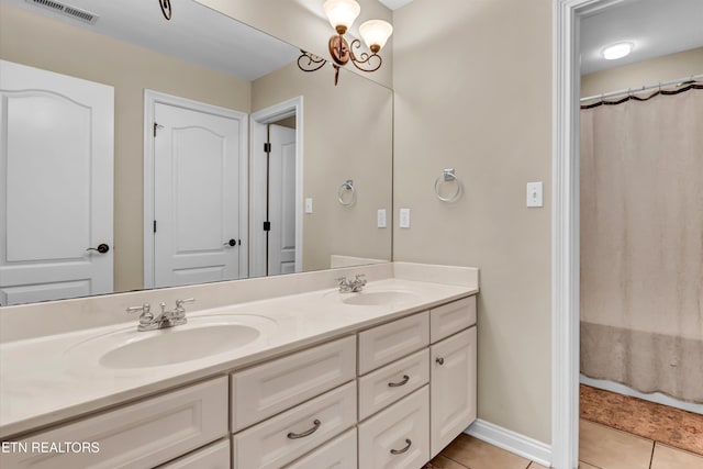 bathroom with vanity, curtained shower, tile patterned floors, and a chandelier