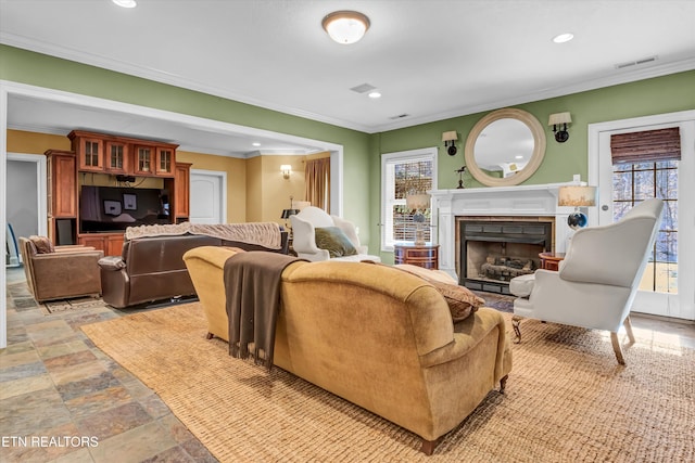 living room with plenty of natural light and ornamental molding