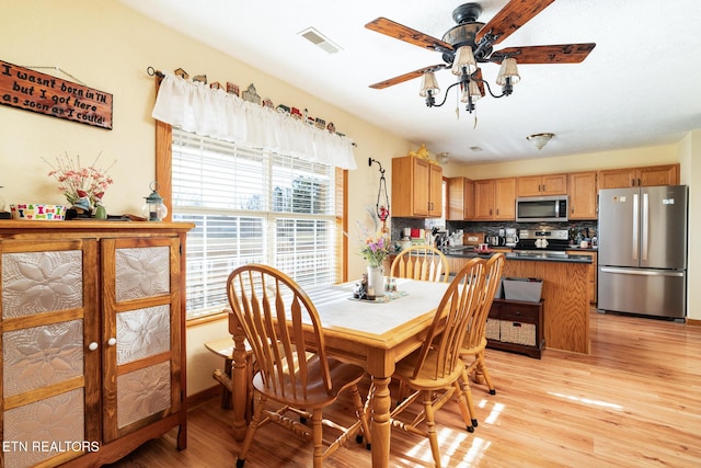 dining area featuring ceiling fan and light hardwood / wood-style floors