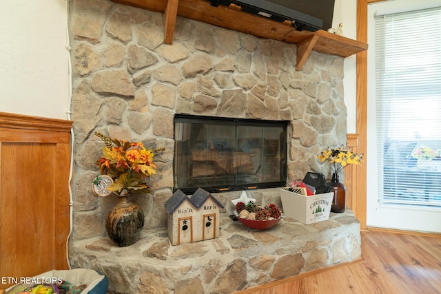 room details featuring a fireplace and wood-type flooring