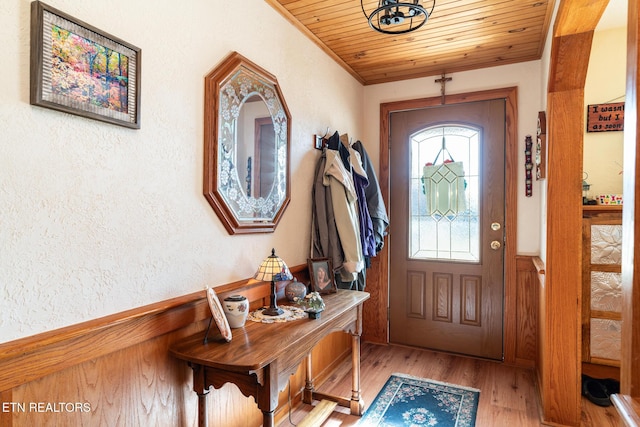 entrance foyer with wood ceiling and light hardwood / wood-style flooring