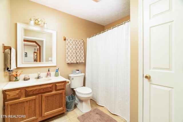 bathroom with tile patterned floors, vanity, toilet, and a textured ceiling