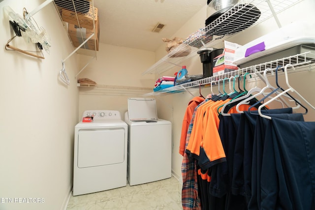 washroom featuring washer and clothes dryer