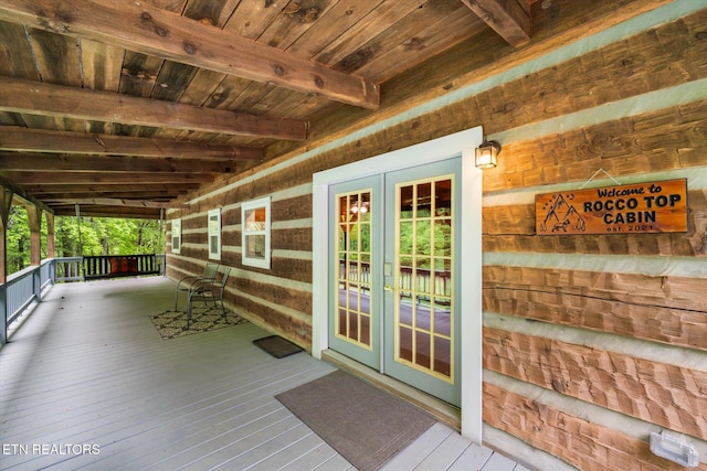 wooden deck with a porch and french doors