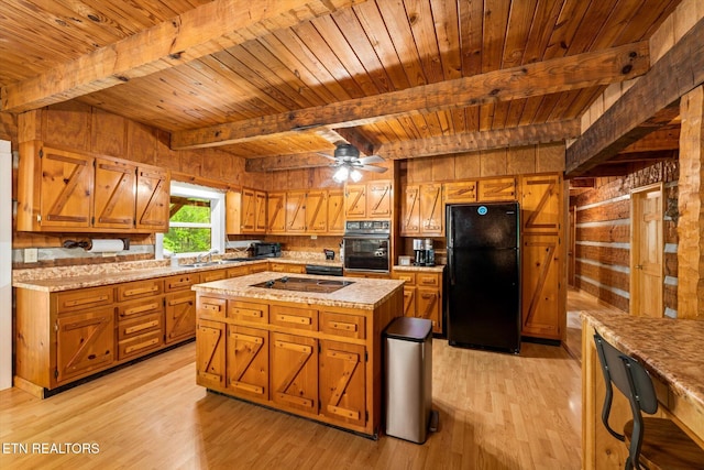 kitchen featuring wooden ceiling, a center island, light hardwood / wood-style floors, and black appliances