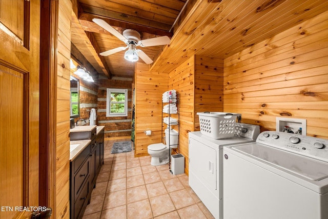 laundry area featuring wood walls, wood ceiling, light tile patterned floors, ceiling fan, and independent washer and dryer