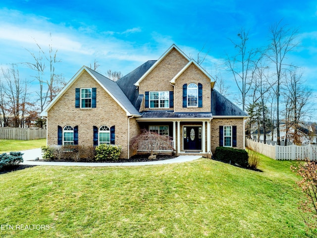 view of front of house featuring a front lawn and covered porch