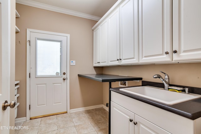 laundry area with sink, cabinets, ornamental molding, washer hookup, and light tile patterned floors