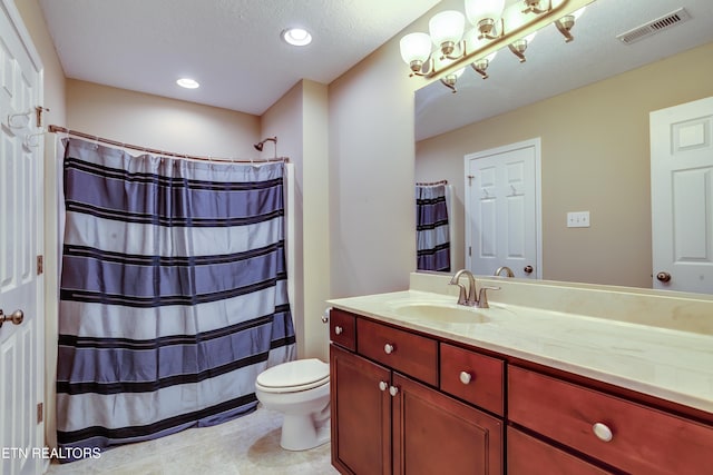 bathroom with vanity, walk in shower, toilet, tile patterned floors, and a textured ceiling