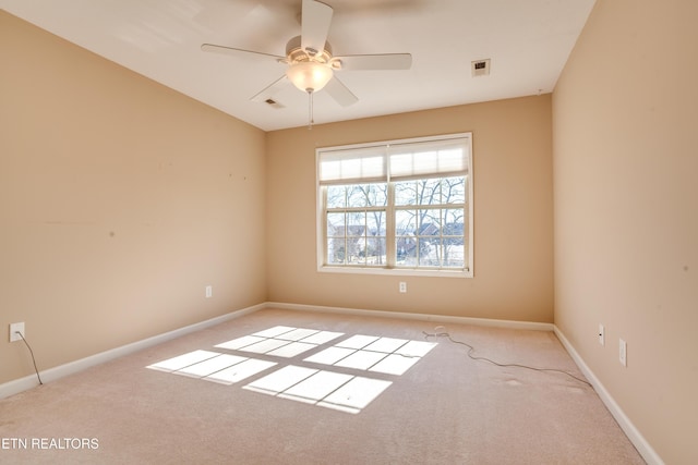 carpeted empty room featuring ceiling fan