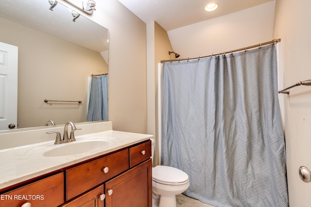 bathroom with vanity, a shower with curtain, and toilet