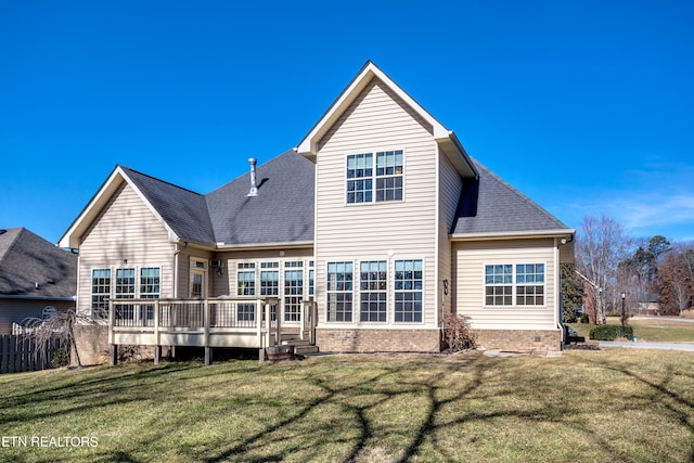 back of house with a wooden deck and a yard