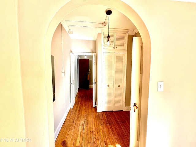 hallway with hardwood / wood-style floors