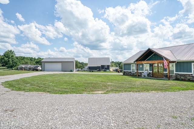 view of front of house with a garage, an outdoor structure, and a front lawn