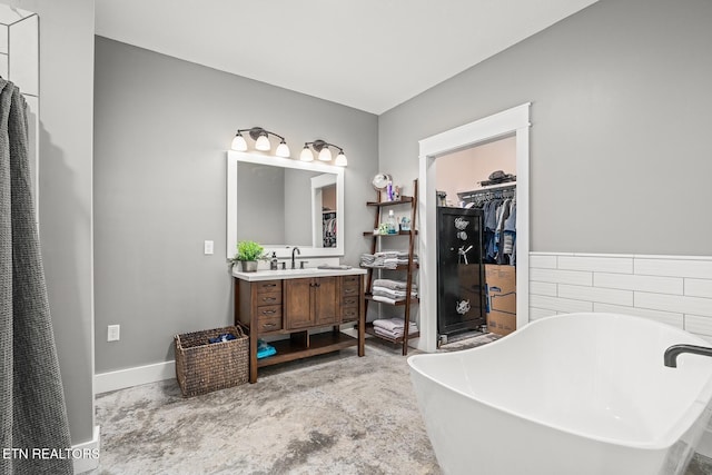 bathroom featuring vanity and a tub to relax in