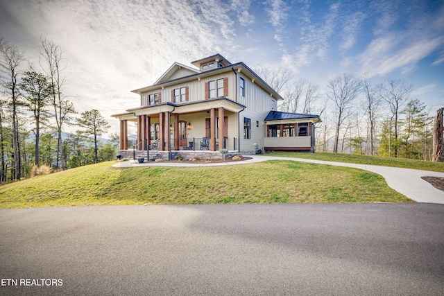 craftsman-style home featuring covered porch and a front yard